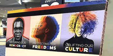 Photo of sign that reads: "Securing Our Democracy", "Protecting Our Freedoms", and "Uplifting Our Culture"