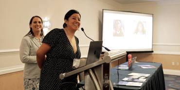 Photo of Wendy Salcedo-Fierro (at microphone) and Taryn Snyder speaking at AFT TEACH 2023