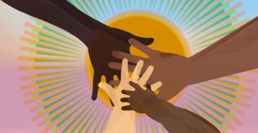 four hands of varying skin color and age meet in front of a sunburst