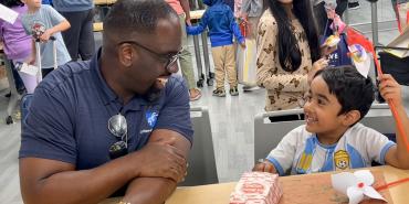  AFT Secretary-Treasurer Fedrick C. Ingram smiling with child