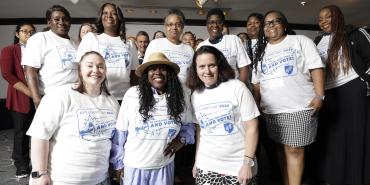 Group in white shirts poses for picture