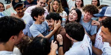 Marcelo Gomes da Silva, center, is embraced by friends outside his home after his release from ICE detention. Boston Globe / Contributor / Getty Images