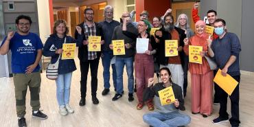 Faculty at the Community College of Baltimore County posing together with signs that say "I stand with my union"