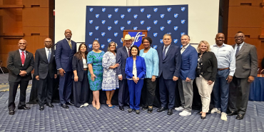A large group of people pose together for a photo at the Human Rights Luncheon. 
