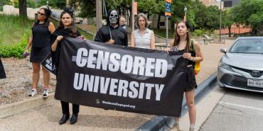 Protesters holding banner that reads Censored University