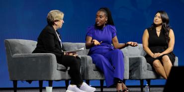 Randi Weingarten, Tiffany Aliche and Aissa Canchola Bañez sit on stage having a discussion in front of an audience at the AFT convention.