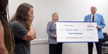 Education West Virginia Co-Presidents Kristie Skidmore and Dale Lee hold up a giant $10,000 check for Becky Turner, at left.