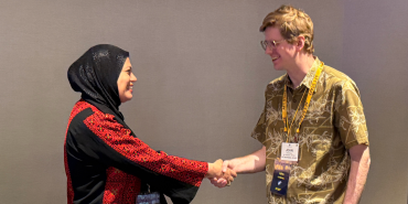 An AFT member greets an international visitor at the convention.
