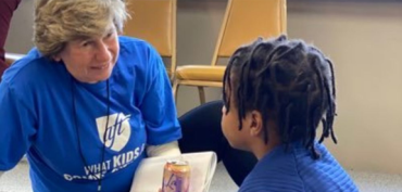 AFT President Randi Weingarten reading with a young child