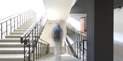 a student, not in focus, walks in a school building