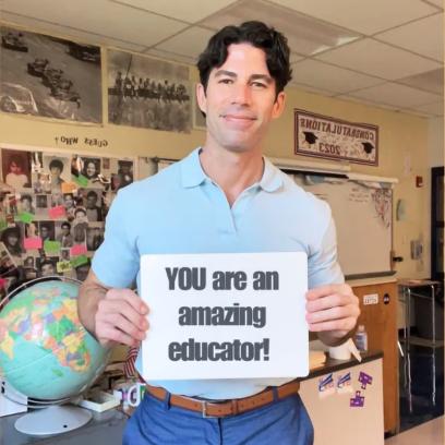 Teacher holding a sign that says "YOU are an amazing educator!"