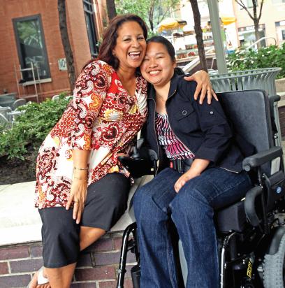 Paraprofessional Margaret Espinoza, left, with former student Becky Zang 10 years after 9/11, when the para wheeled and carried her student away from the World Trade Center.  Credit: Bruce Gilbert