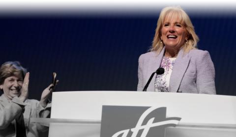 First Lady Dr. Jill Biden speaking in Boston at AFT Convention 2022. AFT President Randi Weingarten applauds the speech.
