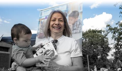 Photo of woman holding a child and both holding a book in Nashua, NH.