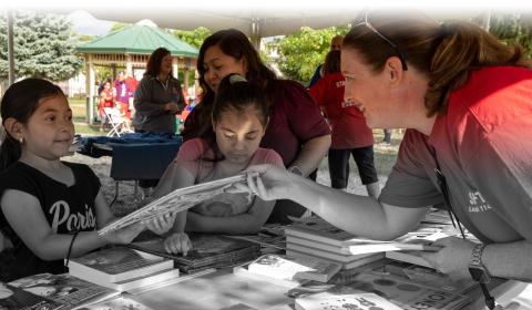 Photo of books being handed out to children