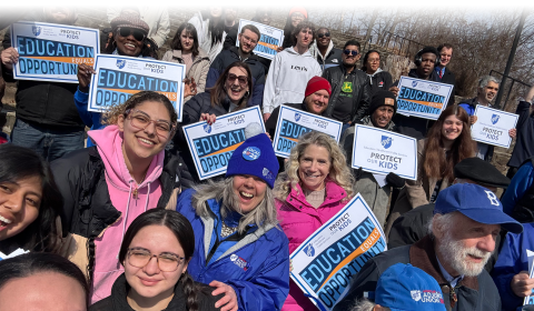 Community members and union members rallying to Protect Our Kids