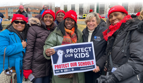 AFT President Randi Weingarten with NYSUT members at a March 4th event. Sign reads "Protect Our Kids. Protect Our Schools."