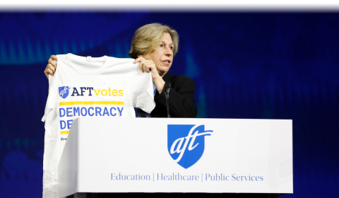 AFT President Randi Weingarten holds up a Democracy Defenders t-shirt at AFT's 2026 Convention in Washington D.C, July 17, 2026.